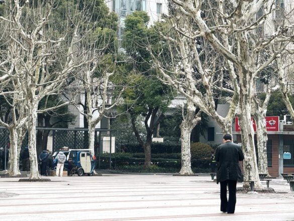 A man walking at the Huai Hai Park in Huangpu, Shanghai.