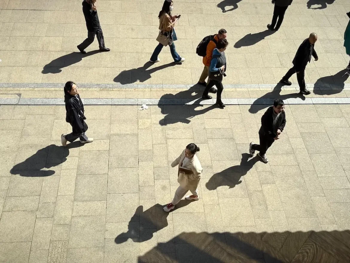 Pedestrians at Peace Hotel, Shanghai.