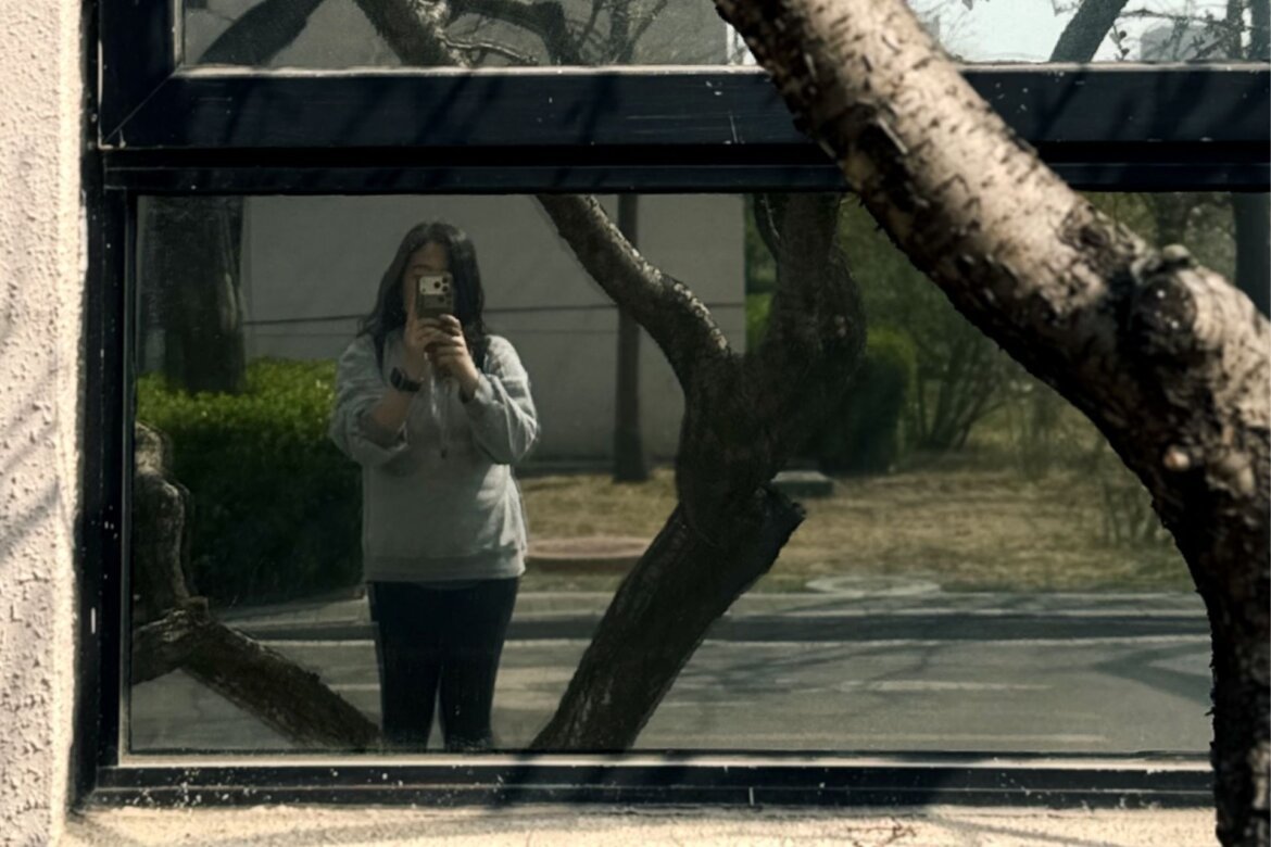 A reflection photograph taken in Beijing, blending the real scene with its mirrored counterpart to create a layered image where reality and reflection coexist.